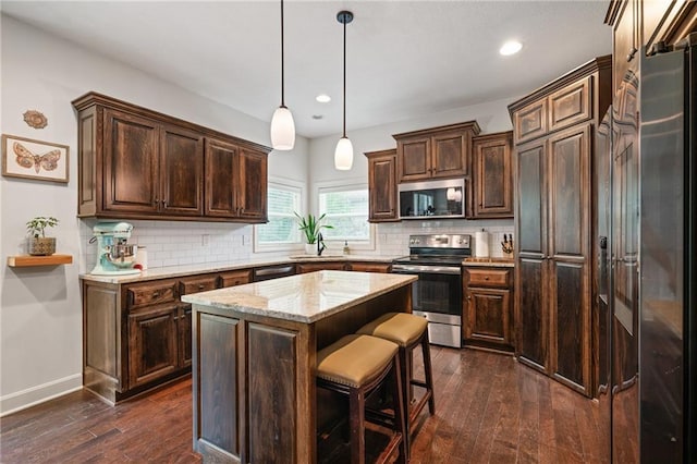 16154 S Canton St, Gardner, KS 66030 - kitchen featuring stainless steel appliances, dark wood-style flooring, recessed lighting, dark brown cabinets, and decorative backsplash