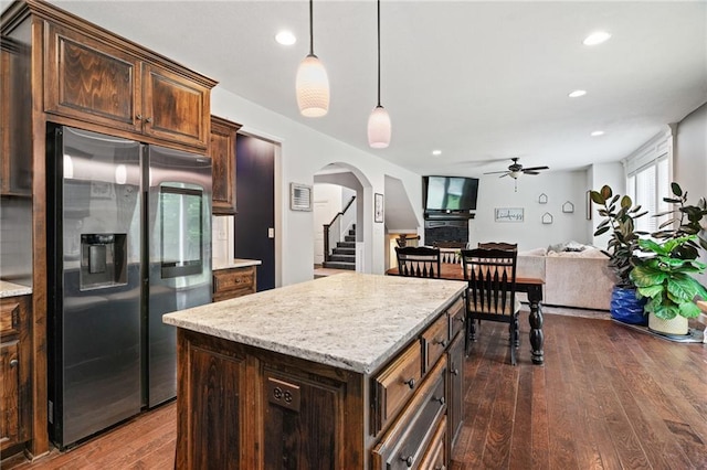 16154 S Canton St, Gardner, KS 66030 - kitchen featuring stainless steel fridge with ice dispenser, arched walkways, a ceiling fan, dark wood-style floors, and pendant lighting