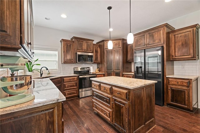 16154 S Canton St, Gardner, KS 66030 - kitchen with appliances with stainless steel finishes, tasteful backsplash, dark wood-style floors, light stone countertops, and recessed lighting