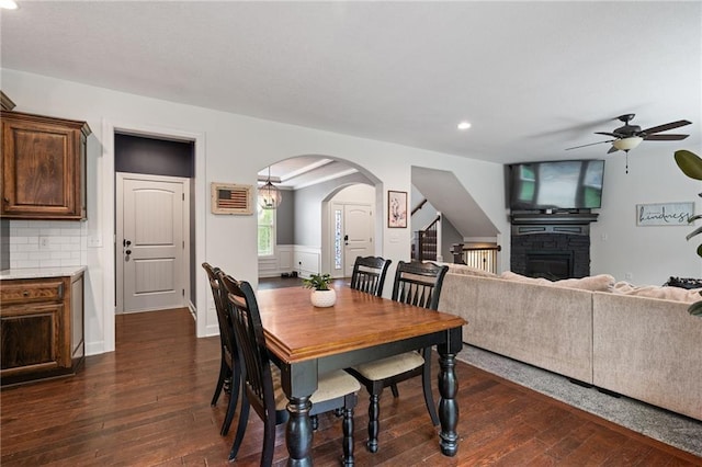 16154 S Canton St, Gardner, KS 66030 - dining space with a glass covered fireplace, arched walkways, ceiling fan, dark wood-type flooring, and recessed lighting