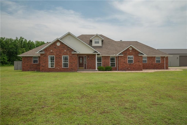 201 S Canary Ln, Commerce, OK 74339 - view of front facade with a front yard, brick siding, a garage, and roof with shingles