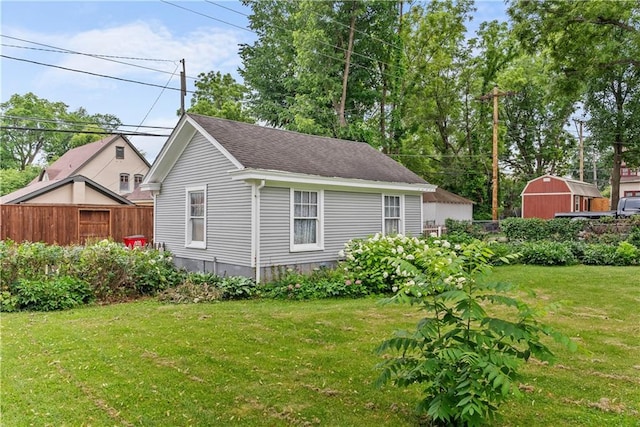 1809 Main St, Lexington, MO 64067 - view of side of property featuring a shed and a shingled roof