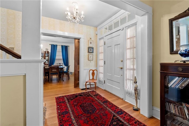 1809 Main St, Lexington, MO 64067 - entryway featuring wallpapered walls, a chandelier, and light wood finished floors