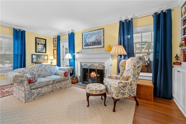 1809 Main St, Lexington, MO 64067 - living area with ornamental molding, wood finished floors, a fireplace, and healthy amount of natural light