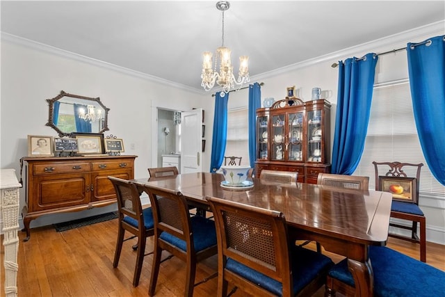 1809 Main St, Lexington, MO 64067 - dining area with a chandelier, ornamental molding, and wood finished floors