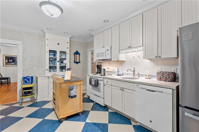 1809 Main St, Lexington, MO 64067 - kitchen featuring white appliances, tile patterned floors, light countertops, ornamental molding, and backsplash