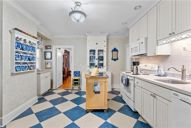 1809 Main St, Lexington, MO 64067 - kitchen with white appliances, light floors, light countertops, white cabinets, and ornamental molding