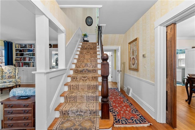 1809 Main St, Lexington, MO 64067 - staircase with wallpapered walls, wood finished floors, and built in shelves
