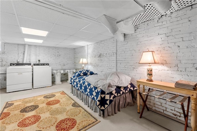 1809 Main St, Lexington, MO 64067 - bedroom featuring concrete flooring, brick wall, a drop ceiling, and washing machine and clothes dryer