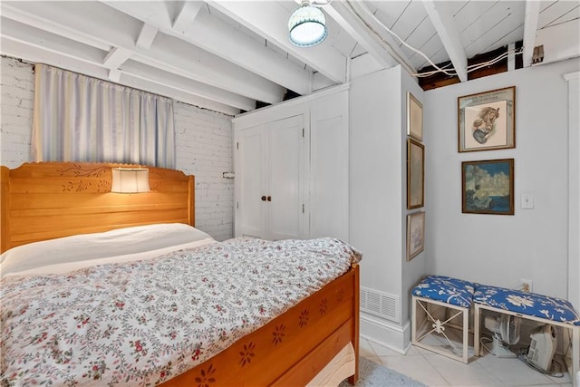 1809 Main St, Lexington, MO 64067 - tiled bedroom with brick wall and beam ceiling