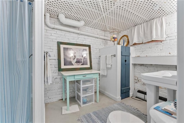 1809 Main St, Lexington, MO 64067 - bathroom featuring unfinished concrete floors and brick wall