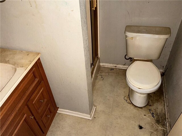 13 Oak Crest Dr, Linn Valley, KS 66040 - bathroom featuring vanity, a shower with door, baseboards, and toilet