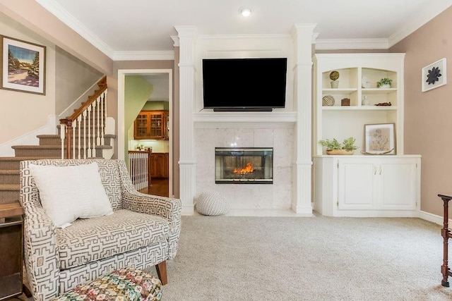 14810 W 72nd St, Shawnee, KS 66216 - carpeted living area featuring stairway, crown molding, a premium fireplace, and ornate columns