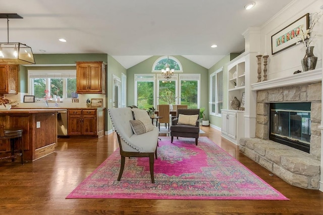14810 W 72nd St, Shawnee, KS 66216 - living area featuring a chandelier, dark wood finished floors, vaulted ceiling, a fireplace, and recessed lighting