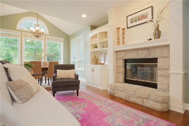 14810 W 72nd St, Shawnee, KS 66216 - living area featuring a chandelier, wood finished floors, lofted ceiling, and a stone fireplace