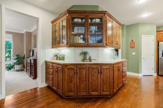 14810 W 72nd St, Shawnee, KS 66216 - bar area featuring dark wood-style floors, stainless steel fridge, crown molding, and backsplash
