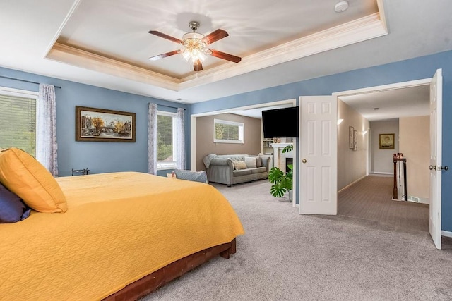 14810 W 72nd St, Shawnee, KS 66216 - bedroom with a tray ceiling, ornamental molding, multiple windows, light colored carpet, and ceiling fan