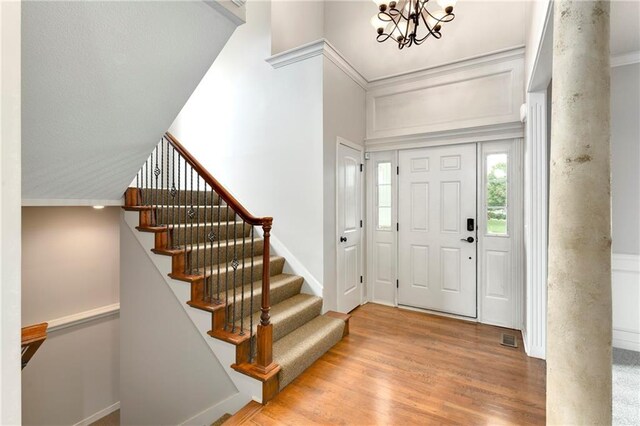 21835 W 175th Ter, Olathe, KS 66062 - entryway featuring wood finished floors, stairs, and a chandelier