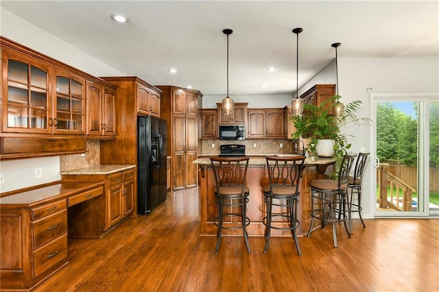 21835 W 175th Ter, Olathe, KS 66062 - kitchen with black appliances, a peninsula, dark wood-style flooring, glass insert cabinets, and backsplash