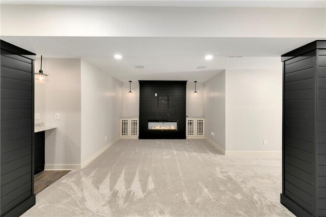 21835 W 175th Ter, Olathe, KS 66062 - unfurnished living room with light colored carpet, a large fireplace, and recessed lighting