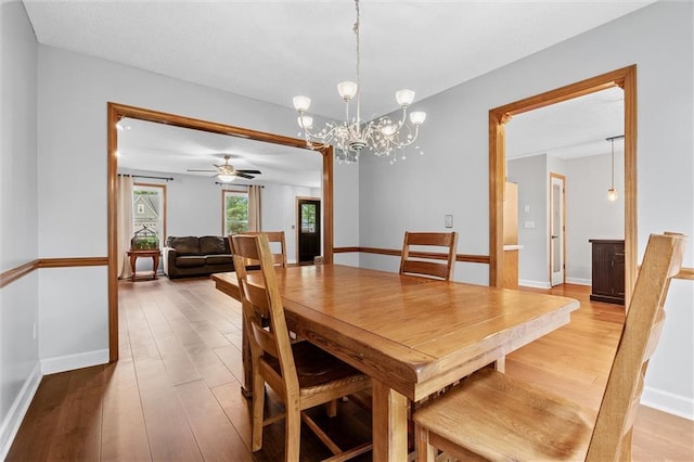 8604 NE 72nd Ter, Kansas City, MO 64158 - dining space with light wood-style floors, a chandelier, baseboards, and a ceiling fan