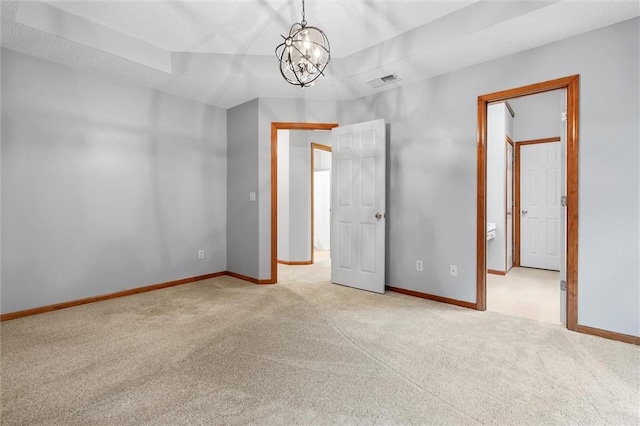 8604 NE 72nd Ter, Kansas City, MO 64158 - empty room with carpet, baseboards, and a chandelier