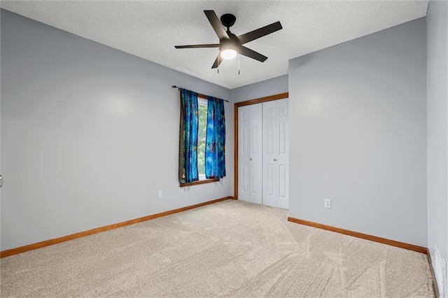8604 NE 72nd Ter, Kansas City, MO 64158 - unfurnished bedroom featuring carpet floors, baseboards, a closet, a textured ceiling, and ceiling fan