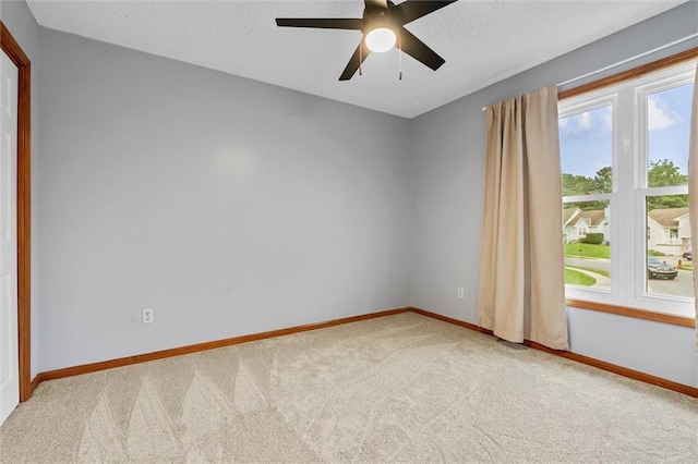 8604 NE 72nd Ter, Kansas City, MO 64158 - carpeted empty room with baseboards and ceiling fan