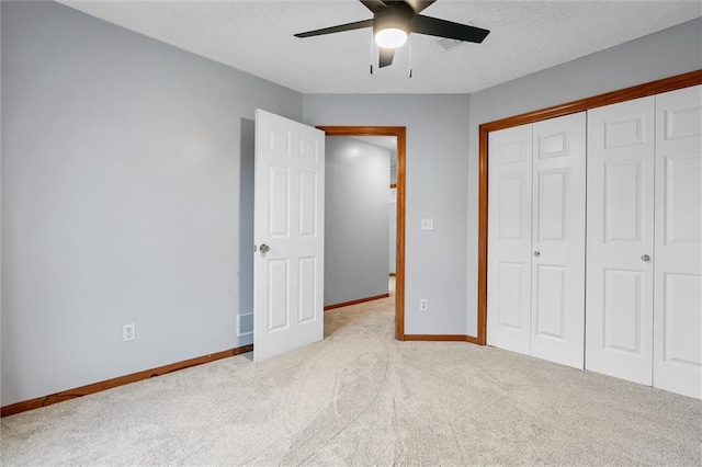 8604 NE 72nd Ter, Kansas City, MO 64158 - unfurnished bedroom with carpet, baseboards, a closet, ceiling fan, and a textured ceiling