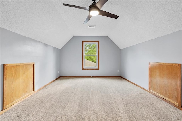 8604 NE 72nd Ter, Kansas City, MO 64158 - additional living space featuring vaulted ceiling, ceiling fan, carpet flooring, a textured ceiling, and baseboards