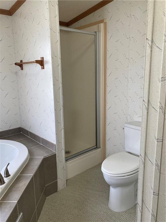 2000 E 19th St Unit 5, Lawrence, KS 66046 - bathroom featuring crown molding, a shower stall, and a garden tub