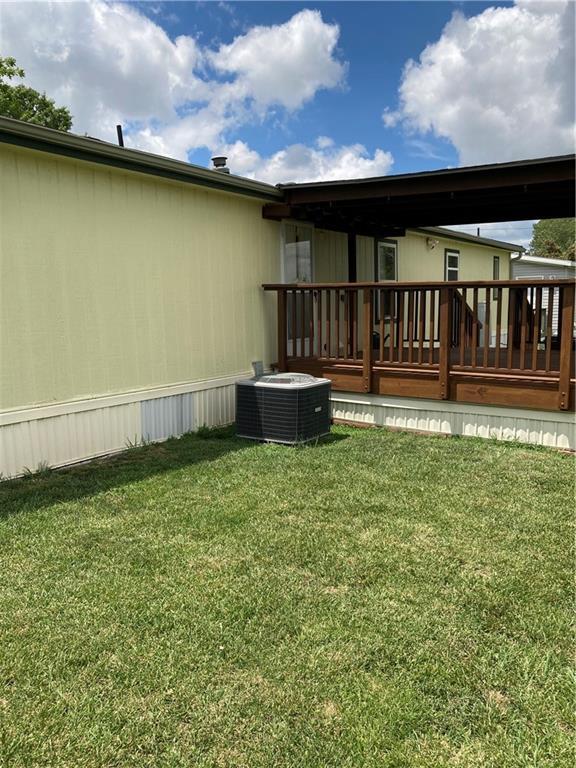 2000 E 19th St Unit 5, Lawrence, KS 66046 - back of property with a wooden deck and a lawn