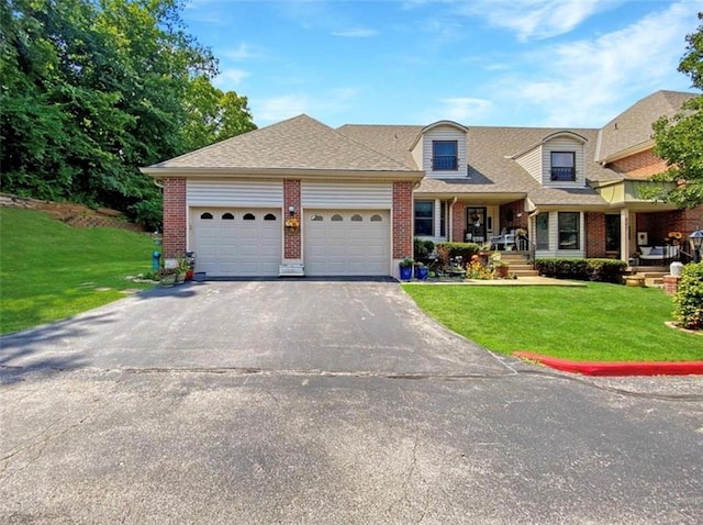 305 E Partridge Ave, Independence, MO 64055 - view of front of home with brick siding, driveway, a garage, and a front yard
