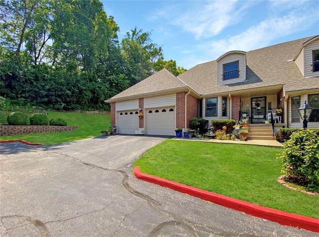 305 E Partridge Ave, Independence, MO 64055 - view of front facade featuring asphalt driveway, brick siding, a front lawn, an attached garage, and roof with shingles