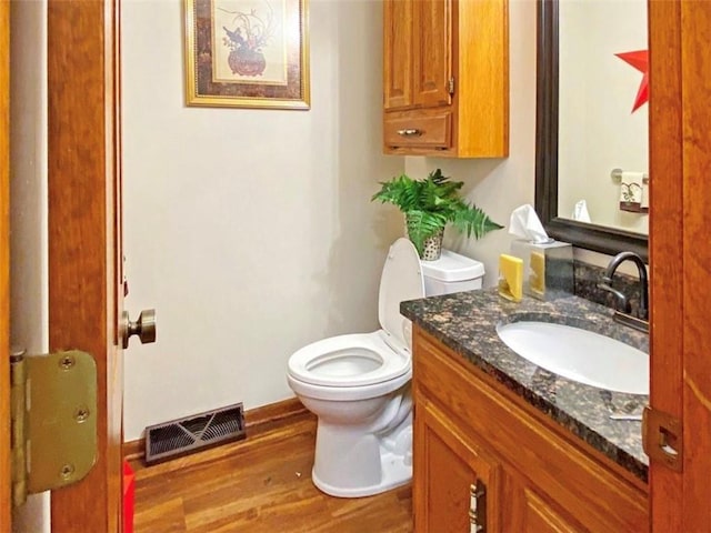 305 E Partridge Ave, Independence, MO 64055 - bathroom featuring vanity, wood finished floors, and toilet