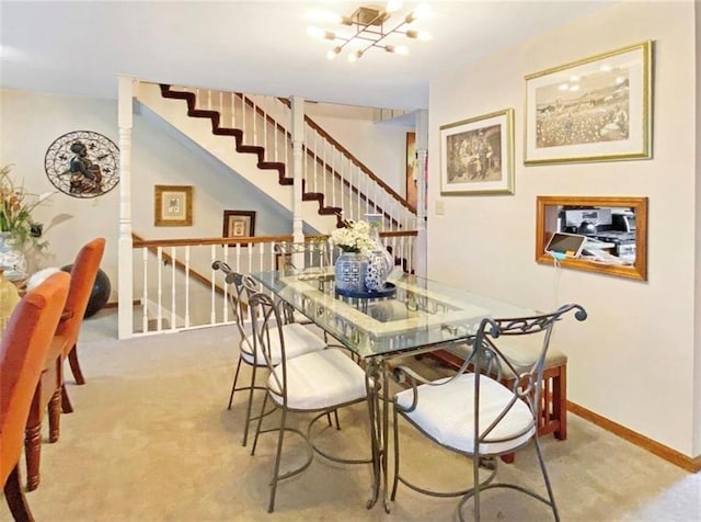305 E Partridge Ave, Independence, MO 64055 - carpeted dining room featuring a chandelier, baseboards, and stairway