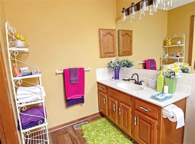 305 E Partridge Ave, Independence, MO 64055 - bathroom with vanity, wood finished floors, and baseboards