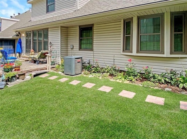 305 E Partridge Ave, Independence, MO 64055 - view of grassy yard with central AC and a wooden deck