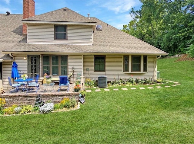 305 E Partridge Ave, Independence, MO 64055 - rear view of property with a lawn, a shingled roof, a patio area, a chimney, and cooling unit