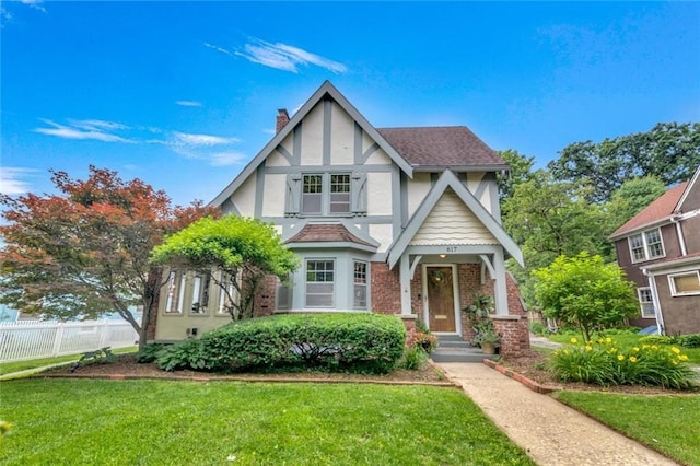 617 E 64th Ter, Kansas City, MO 64131 - tudor house with stucco siding, a chimney, and brick siding