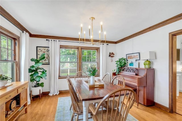 617 E 64th Ter, Kansas City, MO 64131 - dining room with a chandelier, ornamental molding, light wood-type flooring, and baseboards
