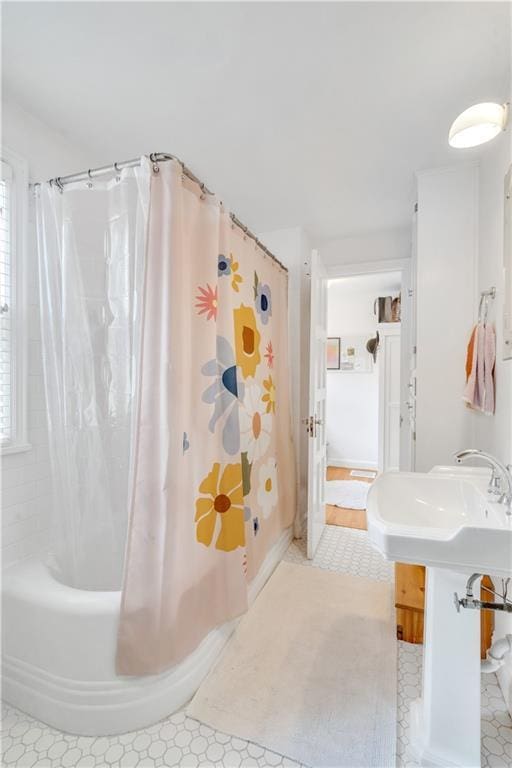 617 E 64th Ter, Kansas City, MO 64131 - bathroom with shower / bathtub combination with curtain and a sink