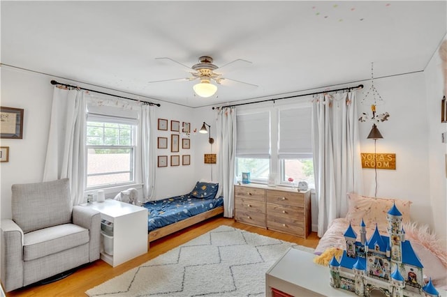 617 E 64th Ter, Kansas City, MO 64131 - bedroom with light wood finished floors and ceiling fan