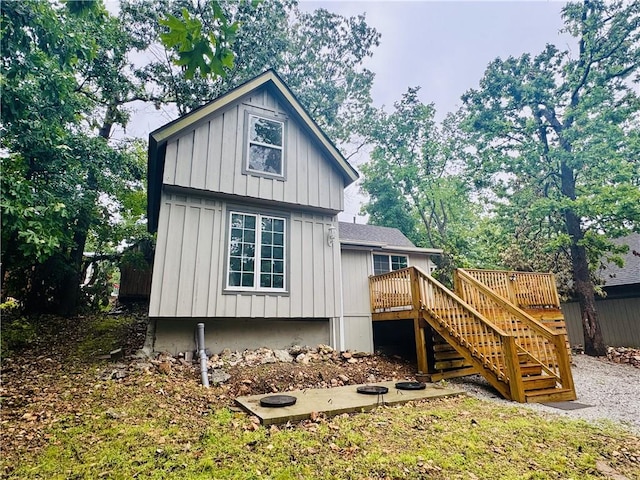 10057 Otter Rd, Clinton, MO 64735 - rear view of house featuring stairs, board and batten siding, and a wooden deck