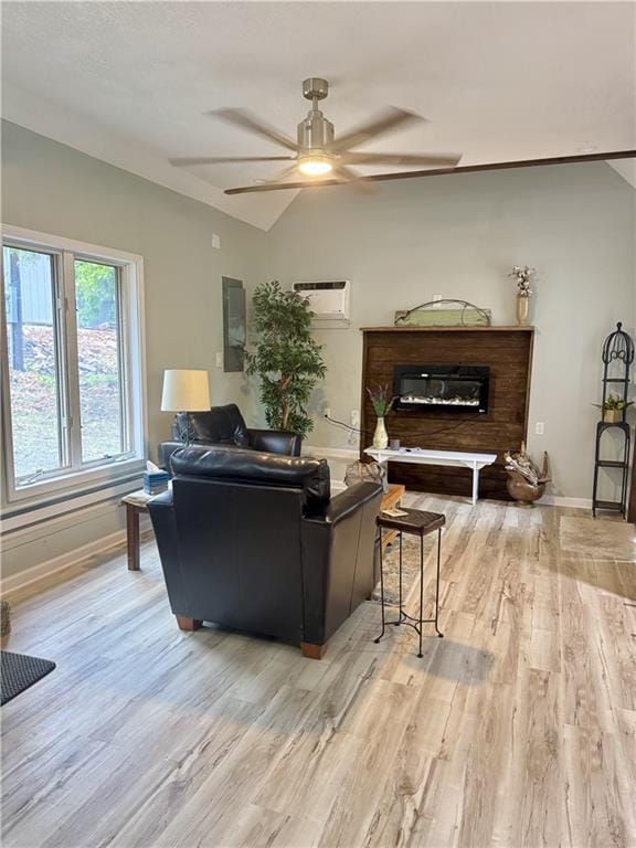 10057 Otter Rd, Clinton, MO 64735 - living room with light wood finished floors, baseboards, a ceiling fan, a wall mounted air conditioner, and vaulted ceiling