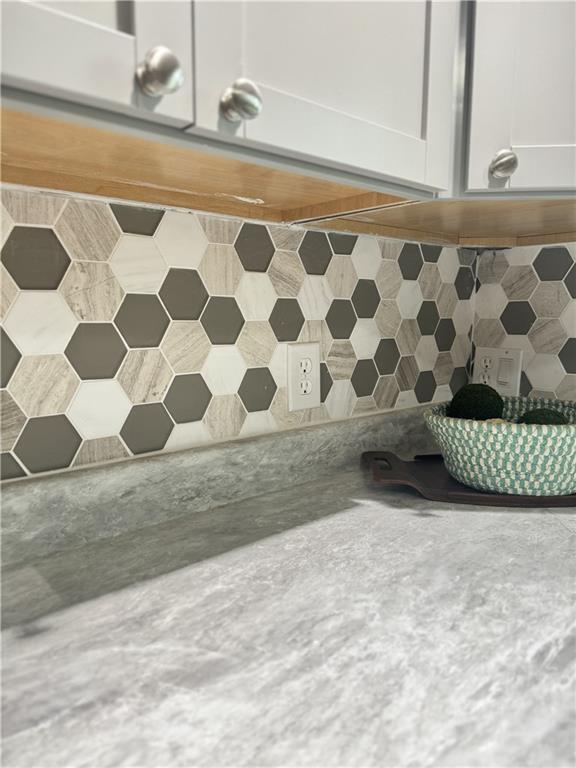 10057 Otter Rd, Clinton, MO 64735 - kitchen view of decorative backsplash and white cabinets