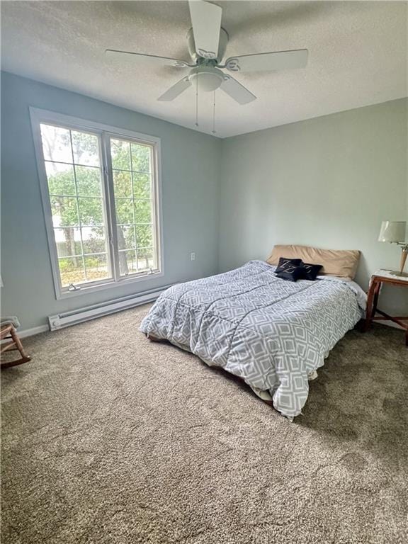 10057 Otter Rd, Clinton, MO 64735 - carpeted bedroom with a textured ceiling, a baseboard radiator, ceiling fan, and baseboards