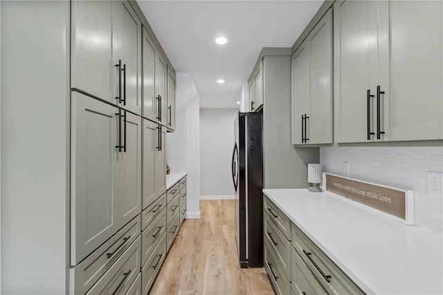 11917 W 66th St, Shawnee, KS 66216 - kitchen featuring freestanding refrigerator, gray cabinets, light wood finished floors, light countertops, and recessed lighting