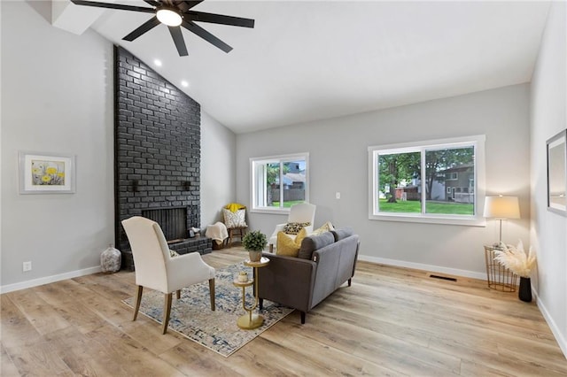 11917 W 66th St, Shawnee, KS 66216 - living area with a ceiling fan, wood finished floors, a brick fireplace, high vaulted ceiling, and recessed lighting