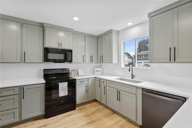 11917 W 66th St, Shawnee, KS 66216 - kitchen featuring black appliances, gray cabinets, decorative backsplash, light countertops, and recessed lighting
